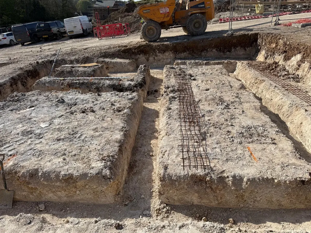 Foundation trenches with steel reinforcement mesh laid ready for concrete