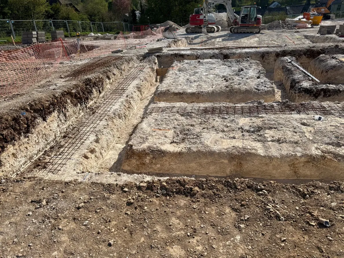 Wide view of foundation trenches and groundworks in progress on a Dorset building site