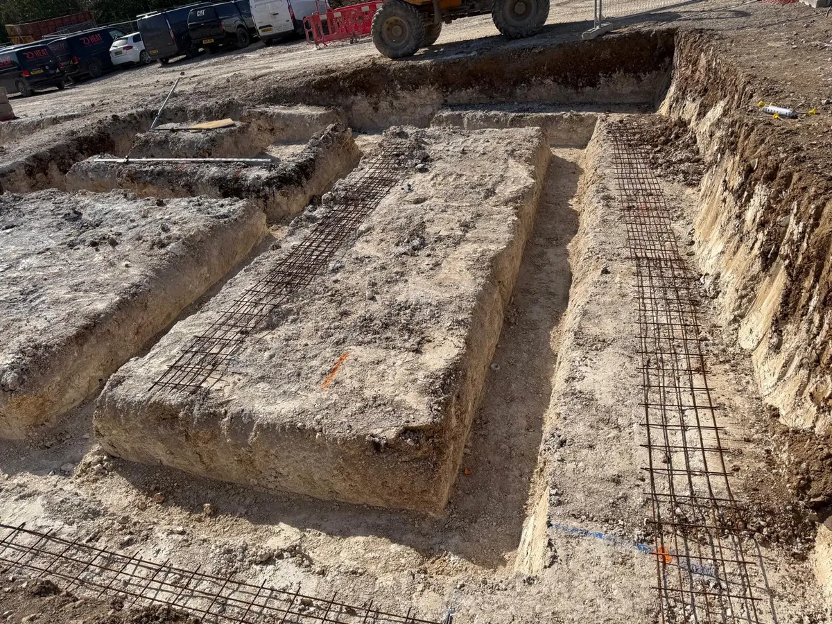 Reinforced concrete strip foundations with steel mesh ready for a new build