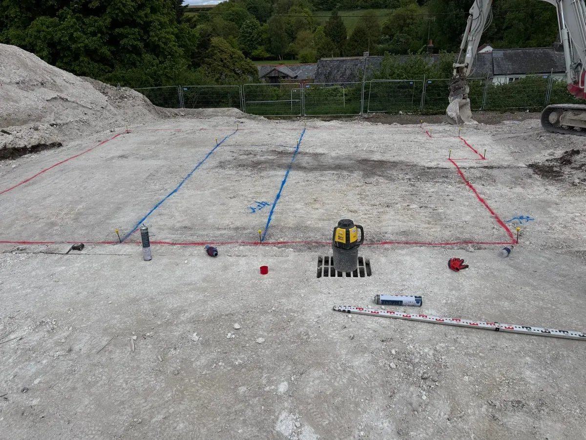 Setting out a foundation footprint with string lines and a laser level
